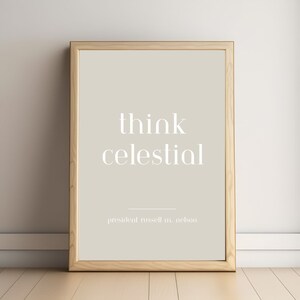 May include: A framed print with the words "think celestial" in white, elegant font on a beige background. The print is in a light wood frame and includes the text "president russell m. nelson" at the bottom.