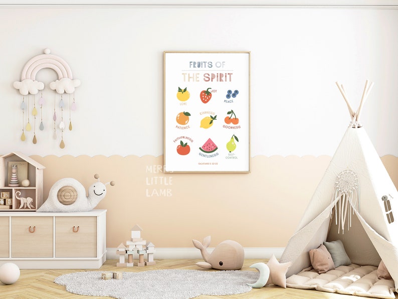 May include: A colorful printable poster with the text "Fruits of the Spirit" and illustrations of fruit representing different virtues, such as joy, peace, patience, kindness, goodness, faithfulness, gentleness, self-control. The poster is framed and hanging on a wall in a nursery with a teepee tent and other children's toys.