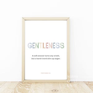 May include: A framed print with the word "GENTLENESS" in colourful letters. The quote "A soft answer turns any wrath, but a harsh word stirs up anger." is printed below the word. The quote is attributed to Proverbs 15:1.