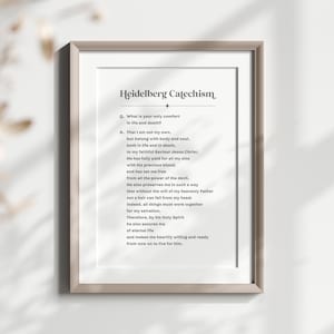 May include: A framed print of the Heidelberg Catechism, a religious text, with a white background and black text. The text includes the question "What is your only comfort in life and death?" and the answer, which begins with "That I am not my own, but belong with body and soul..."