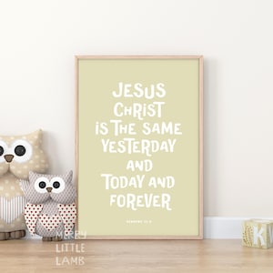 May include: A beige framed print with a light green background and white text that reads "Jesus Christ is the same yesterday and today and forever" with the scripture reference "Hebrews 13:8". Two brown owl stuffed toys with red hearts are in the foreground.