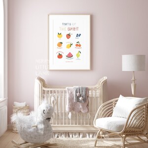 May include: A nursery room with a white crib, a rocking horse, a wicker chair, and a framed print with the text "Fruits of the Spirit" and illustrations of fruit. The print lists the fruits of the spirit: love, joy, peace, patience, kindness, goodness, faithfulness, gentleness, and self-control.