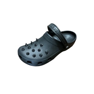 May include: Black Crocs clog with a black strap and black spikes on the top.