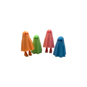 May include: Four colorful ghost figurines in orange, green, pink, and blue. Each ghost has a simple design with two eye holes and small feet. The figurines are standing upright against a white background.