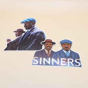 May include: Stickers featuring illustrations of men in suits and hats. One sticker shows three men, while another displays two men with the word "SINNERS" in a distressed font. The men are depicted in various poses.
