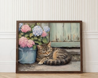 May include: A framed oil painting print featuring a brown tabby cat curled up on a stone surface next to a light blue ceramic pot filled with pink and blue hydrangea flowers, set against a weathered light blue wooden door background.