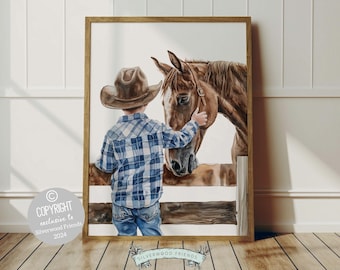 May include: A watercolor painting of a young boy wearing a cowboy hat and a blue plaid shirt, gently touching the nose of a brown horse. The horse has a white star on its forehead and is looking at the boy. The painting is framed in a wooden frame.