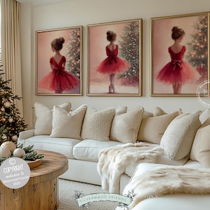 May include: Three framed paintings depict a young girl in a red dress, set against a Christmas tree backdrop. The paintings hang above a white sofa with beige pillows and a faux fur throw. A decorated Christmas tree and a wooden coffee table complete the cozy scene.