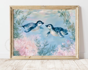 May include: A framed oil painting depicting two penguins swimming underwater amidst soft pink and blue coral-like foliage. The artwork features a light blue background and is encased in a metallic gold frame with a visible watermark at the bottom.