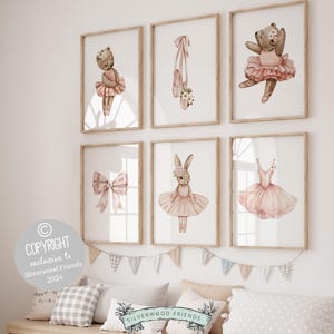 May include: Set of six watercolor prints featuring a ballerina theme. The prints feature a bear, a bunny, a pair of ballet shoes, a bow, and a tutu. The prints are in a light pink and brown color scheme.