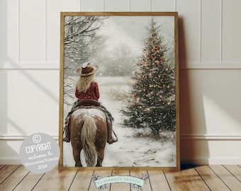 May include: A woman in a red shirt and cowboy hat rides a brown horse through a snowy winter scene. A large Christmas tree with red ornaments and lights is in the background.