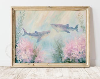 May include: A framed painting featuring two whale sharks swimming through soft, pastel-coloured underwater scenery. The artwork displays light blue and pink hues with gentle brushstrokes, surrounded by aquatic plants in a light-toned wooden frame.
