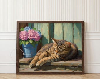 May include: A framed wall art print featuring a brown tabby cat resting with eyes closed on a wooden surface next to a blue pot filled with pink and blue hydrangea flowers. The artwork is set against a light green vertical paneled background.