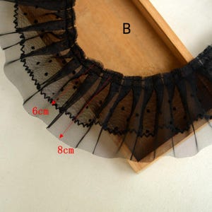 May include: Black lace trim with small polka dots. The trim is 6 inches wide and 8 inches long.