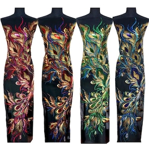 May include: Four pieces of fabric featuring a peacock feather design. The fabric is black with gold, blue, green, and red sequins. The fabric is displayed on a mannequin.