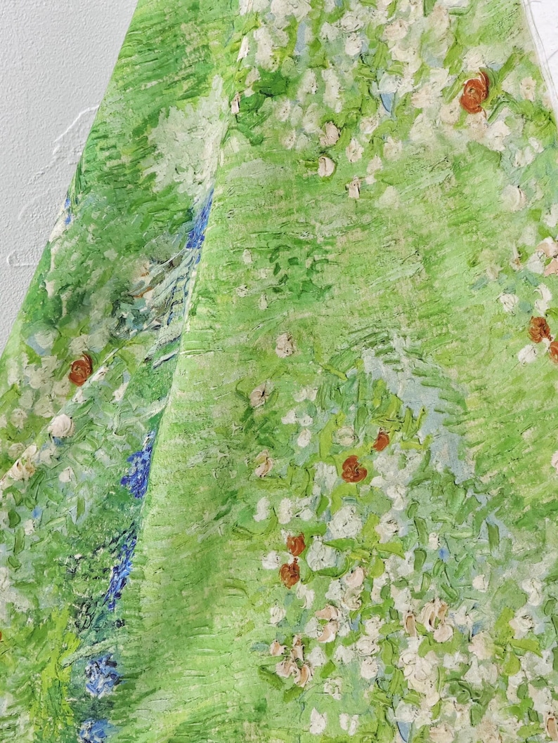 K&ouml;nnte beinhalten: Stoff mit einem gr&uuml;nen, impressionistischen Design mit wei&szlig;en und roten Blumen und blauen Akzenten. Das Kunstwerk erinnert an einen &uuml;ppigen Garten oder eine Wiese, mit sichtbaren Pinselstrichen und einer strukturierten Optik.