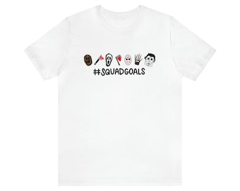 May include: White t-shirt with a black graphic of horror movie characters and the text "#SQUADGOALS".
