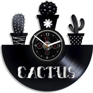 May include: Black vinyl record clock with a white clock face and silver hands. The clock is decorated with three cactus plants in pots. The word "CACTUS" is written in silver lettering on the record.