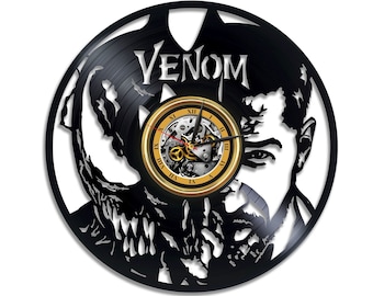 Könnte beinhalten: Schwarze Schallplattenuhr mit einer Silhouette von Venom, einer fiktiven Figur aus Marvel Comics. Das Zifferblatt der Uhr ist golden mit römischen Ziffern und einem schwarzen Zeiger. Der Text "VENOM" ist in Weiß auf die Schallplatte gedruckt.