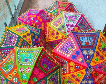 May include: A collection of colorful, decorative umbrellas with intricate embroidered patterns. The umbrellas feature vibrant hues of pink, green, orange, and blue, with detailed floral and geometric designs. Each umbrella has a diameter of approximately 36 inches.