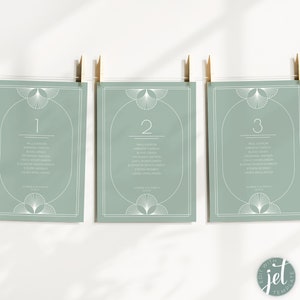 May include: Three light green table number cards with white geometric designs and white text. The cards are numbered 1, 2, and 3. Each card lists a group of names.