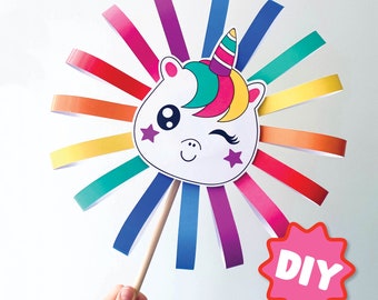 May include: DIY craft project featuring a unicorn head with rainbow streamers attached to a wooden stick. The unicorn has a pink, yellow, and green mane and a blue horn. The words "DIY" are printed on a pink starburst.