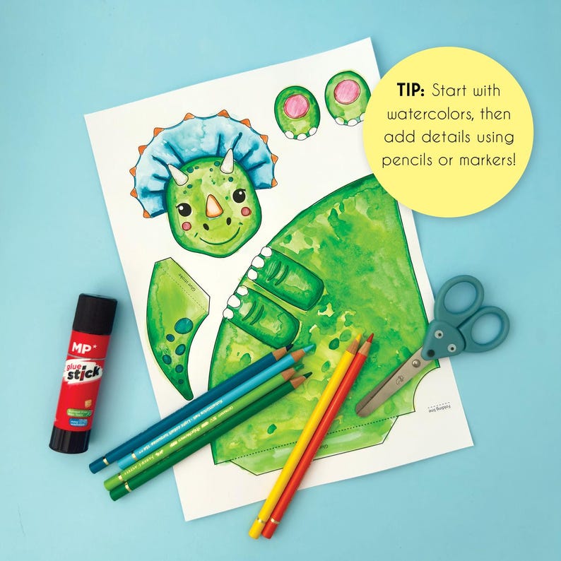 May include: A craft project featuring a green watercolor dinosaur illustration with a blue frill, along with colored pencils, scissors, and a glue stick. The text says, "TIP: Start with watercolors, then add details using pencils or markers!"