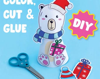 May include: A printable craft activity featuring a polar bear wearing a Santa hat and scarf. The craft includes a DIY label and instructions to color, cut, and glue the pieces together.