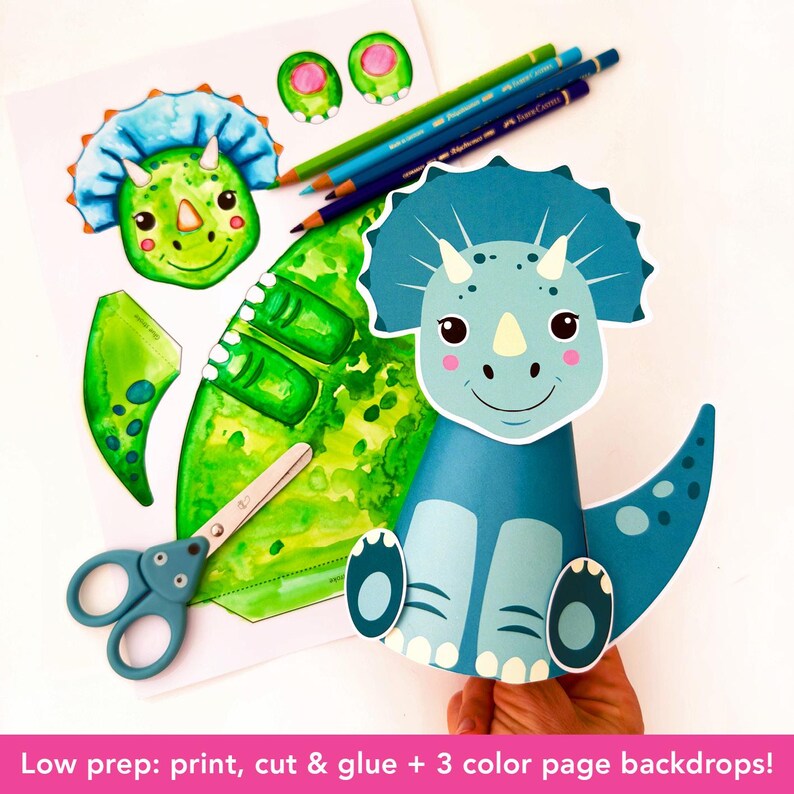 May include: A DIY dinosaur craft kit featuring a blue and green triceratops design. Includes printed paper cutouts, colored pencils, and scissors. The text "Low prep: print, cut & glue + 3 color page backdrops!" is visible.