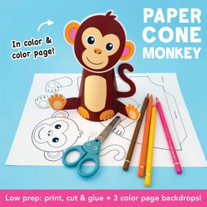 May include: A paper cone monkey craft with the text "PAPER CONE MONKEY". The monkey is brown with a tan belly and orange ears and hands. A pair of blue scissors and colored pencils are next to the monkey on a white sheet of paper. The text "In color & color page!" is also visible.