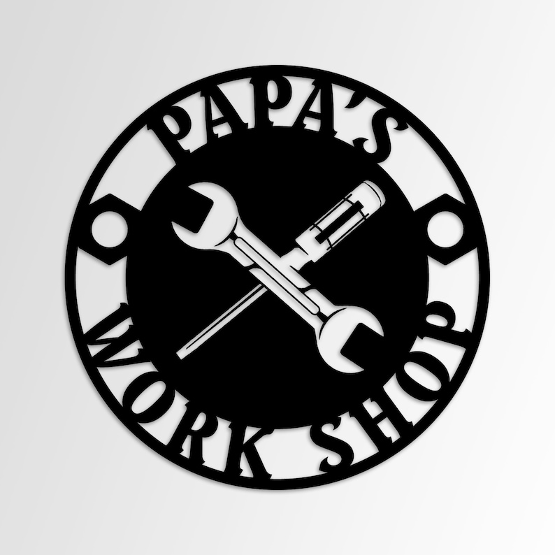 May include: Black metal sign with the words "PAPA'S WORK SHOP" in a circular design. The sign features a crossed wrench and screwdriver in the centre. The sign is a decorative item for a workshop or garage.