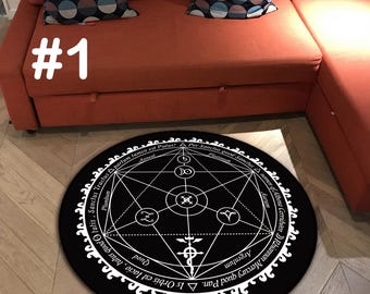 May include: A round black rug with a white alchemical symbol design. The rug features geometric shapes, text, and symbols. The rug is placed on a wooden floor near a red sofa.