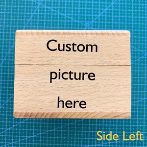 May include: A wooden box with the text "Custom picture here" on the front. The box is light brown and has a natural wood grain. The text is in black and is centered on the box. The box is sitting on a green surface.