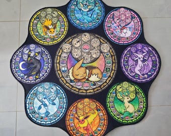 May include: A black, circular rug featuring stained-glass style illustrations of various Pokémon characters. The rug has a central design with Eevee and eight surrounding circular panels, each with a different Pokémon. The rug is designed for decorative use.