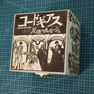May include: A wooden music box with a laser-engraved image of characters from the anime Code Geass: Lelouch of the Rebellion. The box features the Japanese title "コードギアス 反逆のルルーシュ" and the English title "CODE GEASS Lelouch of the Rebellion".
