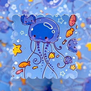 May include: A blue sticker with a cartoon jellyfish design. The jellyfish has a large, round head and long tentacles. Surrounding the jellyfish are other sea creatures, including fish and starfish. The sticker has a scalloped edge.