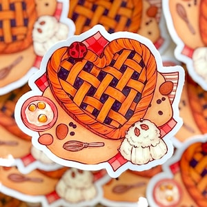 May include: A heart-shaped pie sticker with a lattice crust design, a ladybug, and baking ingredients. The sticker features a red and white checkered cloth, a bowl with eggs, and a whisk. The pie is orange and purple.