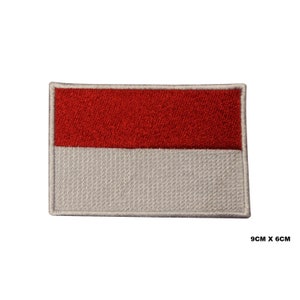 May include: Red and white embroidered patch of the Indonesian flag. The patch is 9 inches by 6 inches.