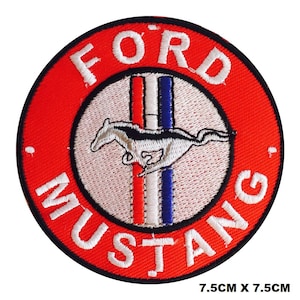 May include: Red and white embroidered patch with the words "Ford Mustang" and a running horse logo. The patch is 7.5 inches by 7.5 inches.