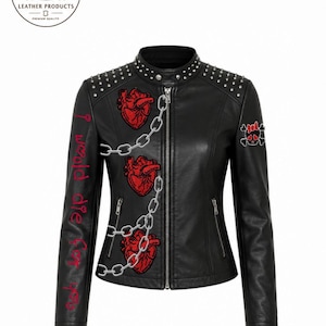 May include: A black leather jacket featuring silver studs on the shoulders, a front zipper, and three red anatomical heart patches connected by a silver chain graphic. The right sleeve displays the red text I would die for you.