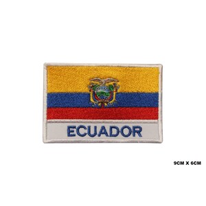 May include: An embroidered patch featuring the flag of Ecuador. The flag is yellow, blue, and red with the Ecuadorian coat of arms in the center. The patch is white with the word "ECUADOR" printed in blue below the flag.
