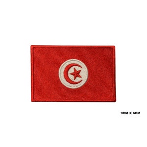 Peut inclure: Patch brodé rouge avec le drapeau de la Tunisie. Le drapeau présente un cercle blanc avec un croissant de lune rouge et une étoile blanche à cinq branches. Le patch mesure 9 cm sur 6 cm.