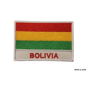 May include: An embroidered patch featuring the flag of Bolivia. The patch is white with a red, yellow, and green horizontal stripe flag in the center. The words "BOLIVIA" are written in red below the flag. The patch measures 9 cm by 6 cm.