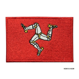 May include: Red embroidered patch with the Isle of Man flag. The flag features a white three-legged symbol on a red background. The patch measures 9 cm by 6 cm.