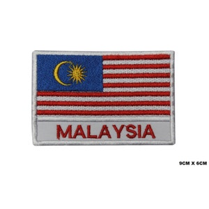 May include: Embroidered patch featuring the Malaysian flag with a yellow crescent moon and star on a blue background, 14 red and white stripes, and the word "MALAYSIA" in red lettering on a white background. The patch measures 9 cm by 6 cm.