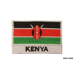 May include: Embroidered patch featuring the flag of Kenya. The flag is red, black, and green with a white shield and two spears in the centre. The patch is 9 cm by 6 cm and has the word "KENYA" written below the flag.