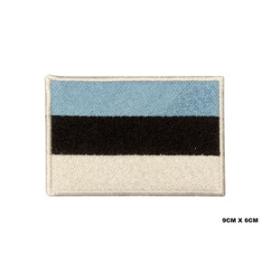 May include: An embroidered patch of the Estonian flag. The flag is blue, black, and white with three horizontal stripes. The patch is 9 cm by 6 cm.