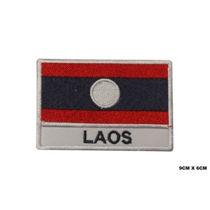 May include: Embroidered patch of the Laotian flag with the words "LAOS" below. The flag is red, blue, and white with a white circle in the center. The patch is 9 cm by 6 cm.