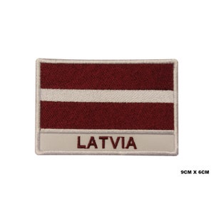 May include: Embroidered patch featuring the Latvian flag with a white stripe on a maroon background. The patch is surrounded by a white border and has the word "LATVIA" written in white below the flag.