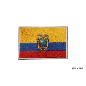 May include: An embroidered patch of the Ecuadorian flag. The flag is yellow, blue, and red with the Ecuadorian coat of arms in the center. The patch is 9 cm by 6 cm.